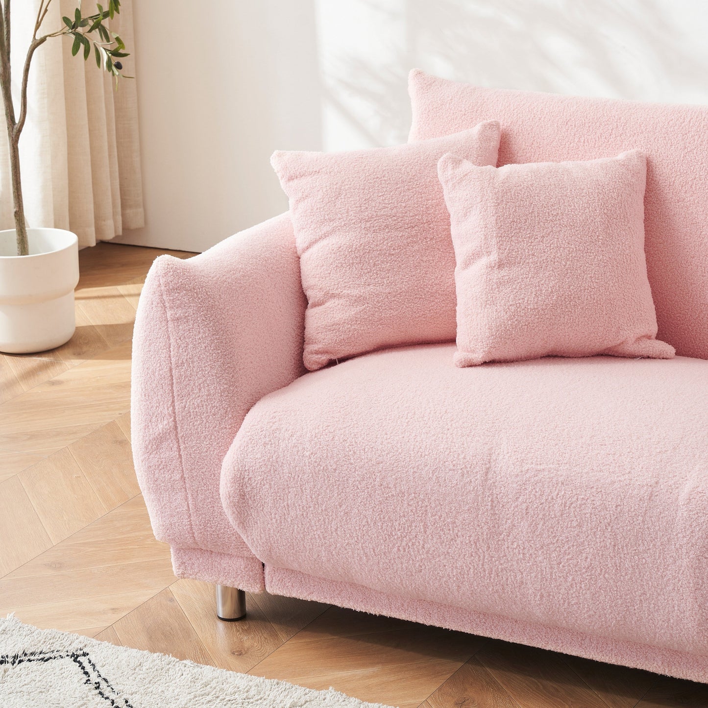 86.6 inch teddy fleece pink sofa with four throw pillows and hardware feet can sit comfortably in an apartment bedroom