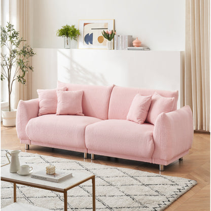 86.6 inch teddy fleece pink sofa with four throw pillows and hardware feet can sit comfortably in an apartment bedroom